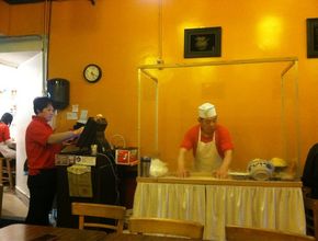 Chef Pulling Noodles at Prep Counter